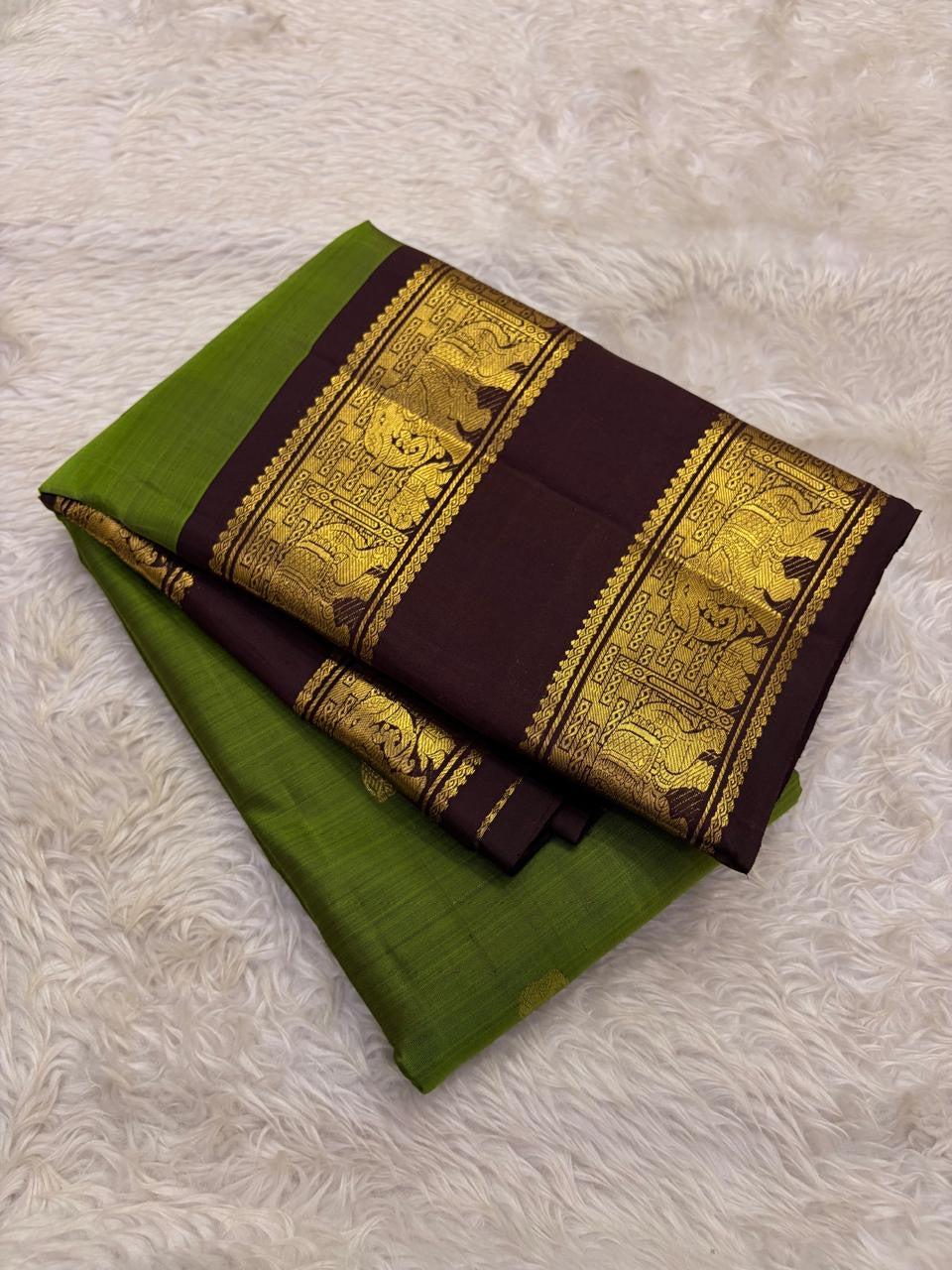 Olive green Kanjivaram silk saree folded showing Rettapet elephant border