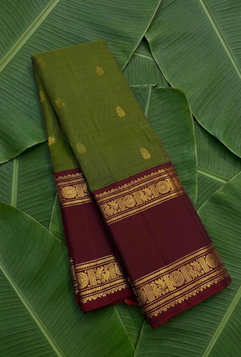 Olive green and maroon handwoven Kanchipuram pure silk saree photographed on banana leaf — Idam Living