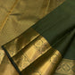 Olive green Kanjivaram saree with petite gold buttas