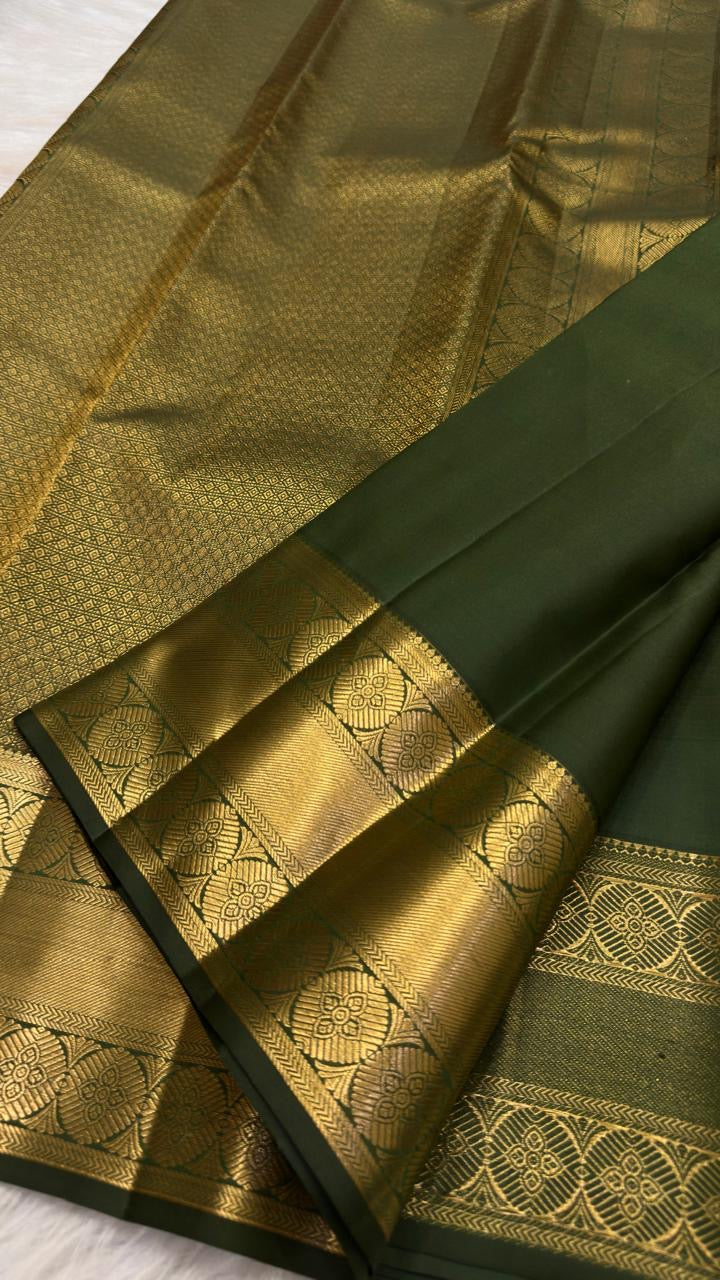 Olive green Kanjivaram saree with petite gold buttas