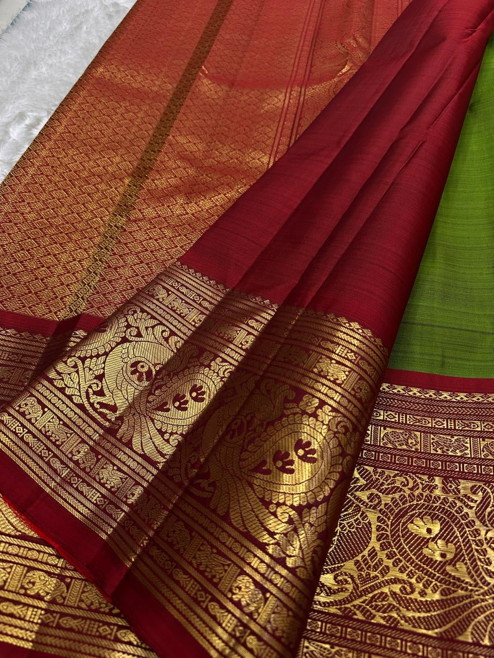 Olive moss green Pure Silk Kanjivaram Korvai saree with vermilion red border and antique gold zari panels