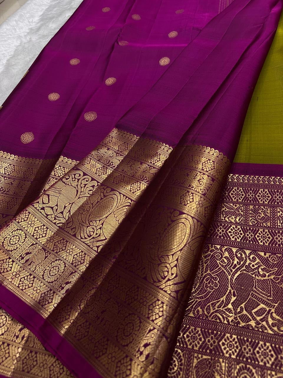 Olive green Pure Silk Kanjivaram Butta saree with magenta contrast and grand heirloom zari craftsmanship