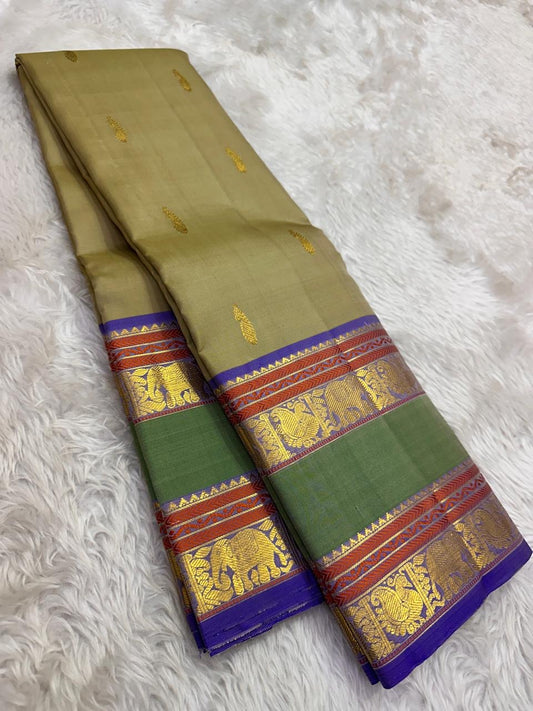 Sage olive Kanjivaram Rettapet saree — antique-gold zari elephant border motif close-up
