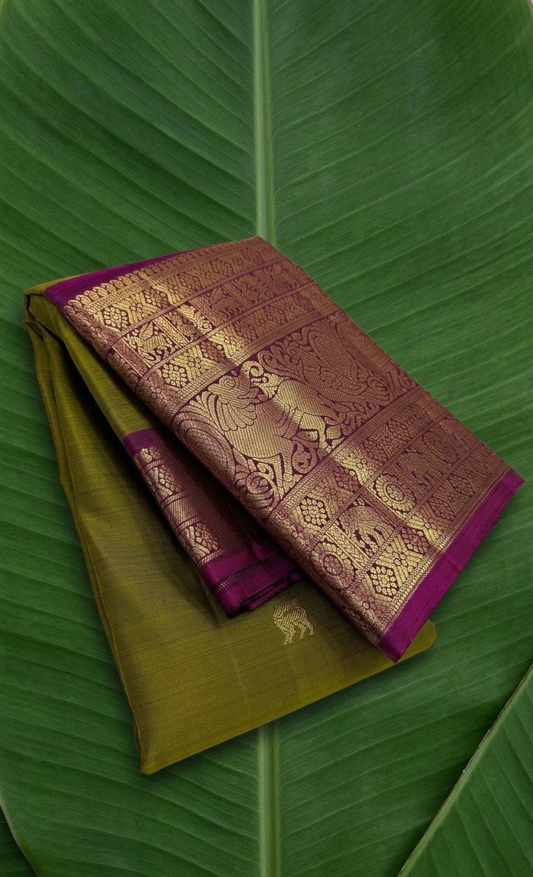 Pure Kanchipuram Butta silk saree in olive moss green with Yazhi motifs and rani magenta border