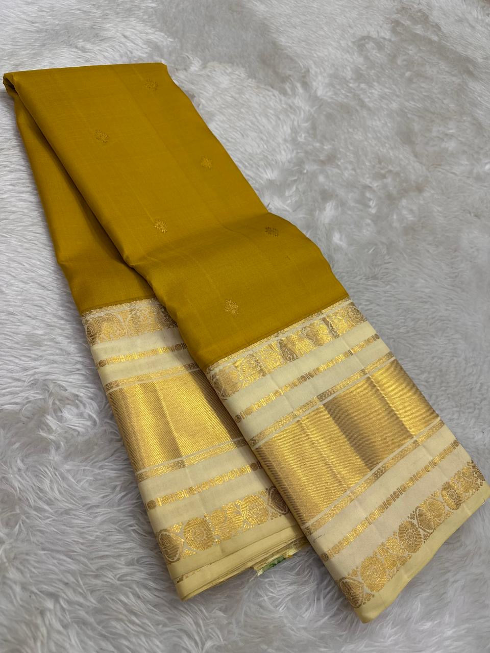 Olive Turmeric Gold Pure Silk Kanchipuram Korvai with Paal Vellai ivory and broad classic-gold zari border.