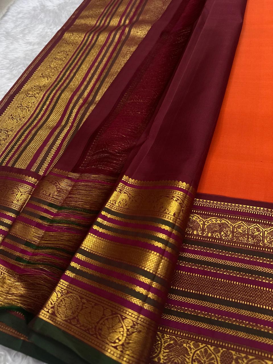 Deep magenta and black pallu with full Varisaipet array in antique gold zari