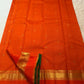 Restrained circular gold-zari butta within the fine grid.