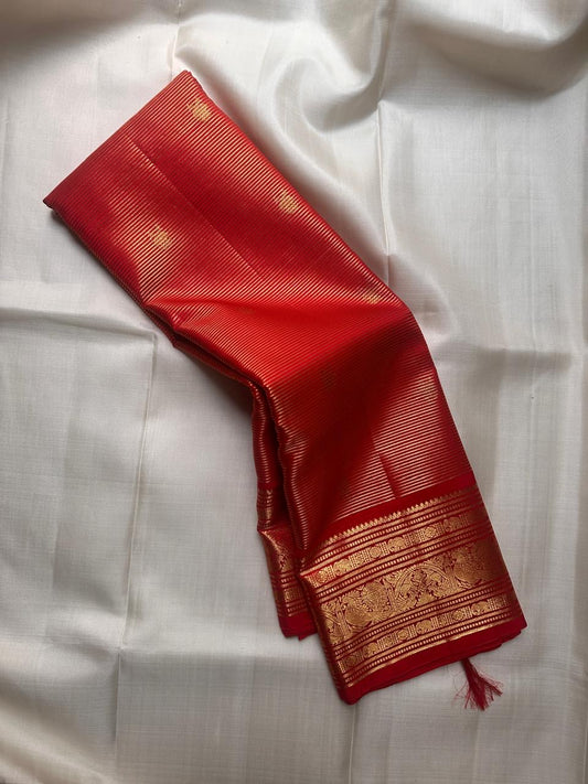 Lustrous red Kanjivaram silk saree with linear zari texture draped view