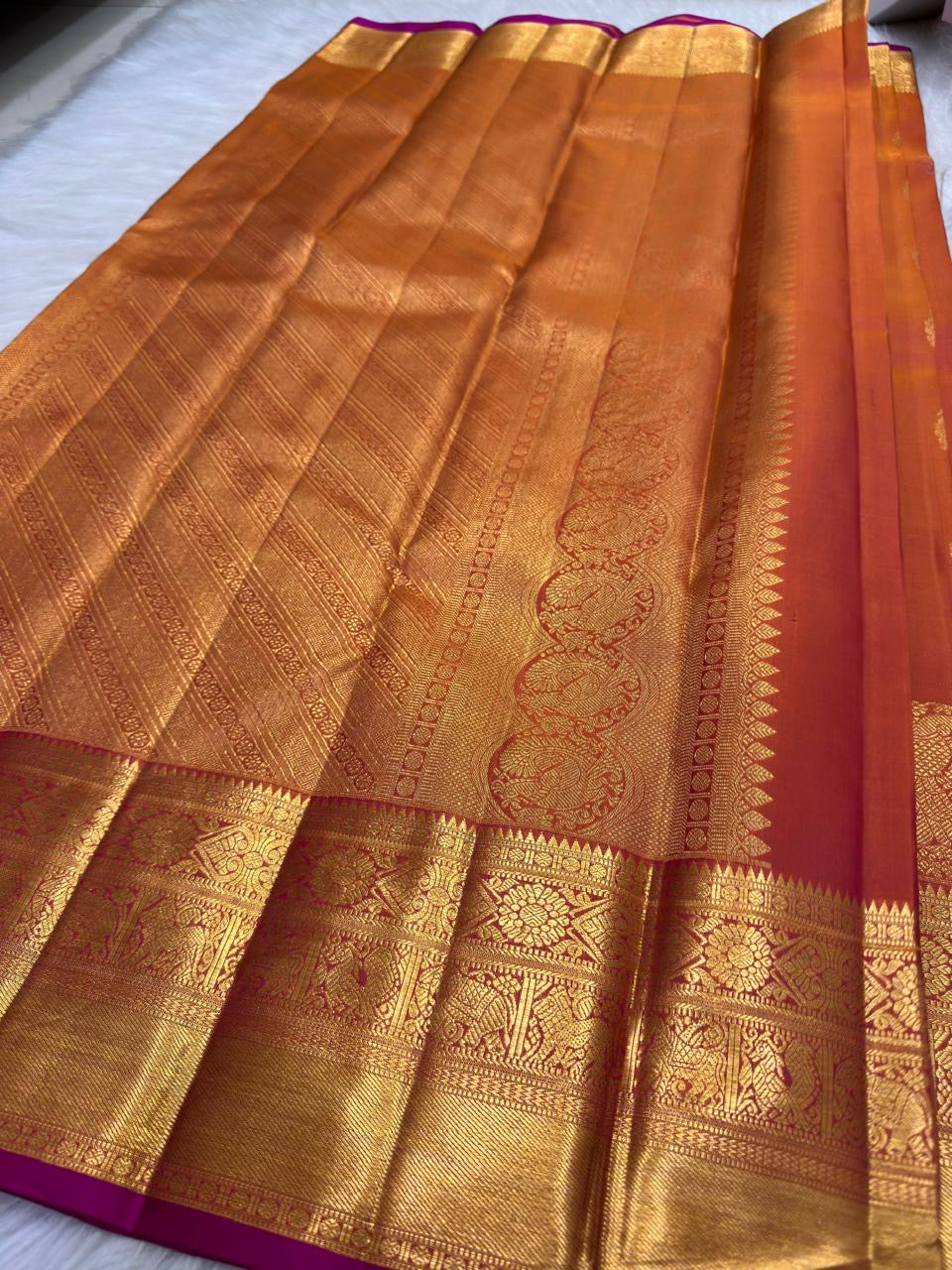 Pure Silk Kanchipuram in Kanakambaram orange with classic gold zari, Mayil motifs and Rani-pink selvedge