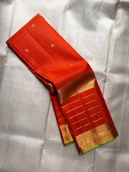 resplendent  orange  silk saree Zari Kattam draped view