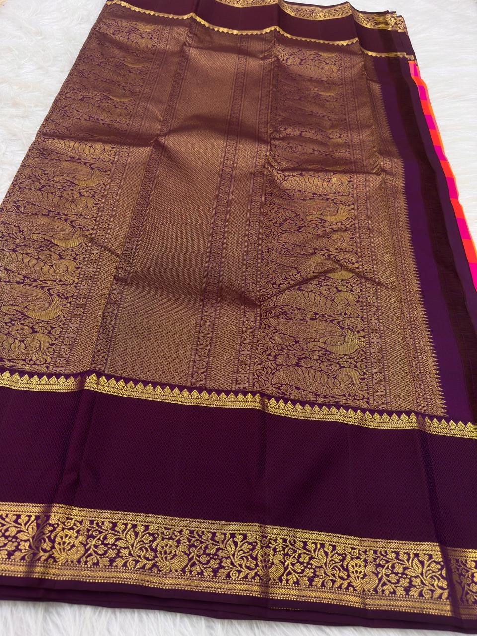 Orange Kanjivaram Paalum Pazhamum saree with a gold-zari border.