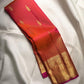 Handwoven orange Kanjivaram silk saree with Rani-pink edge and richly woven Thanga-zari Mayil border