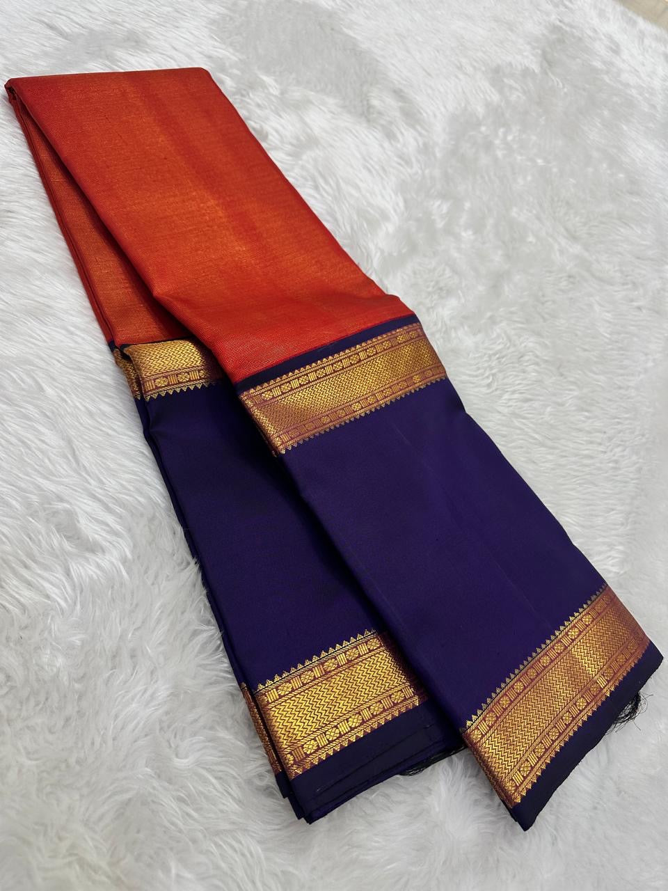Sunset Orange Kanjivaram Rettapet saree with broad navy blue contrast border