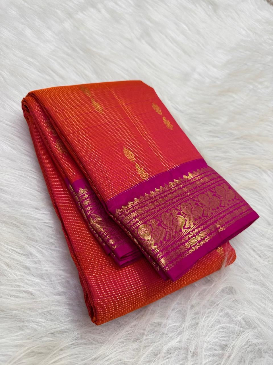 Sunset Orange Pure Silk Kanchipuram saree with Raspberry Pink zari border