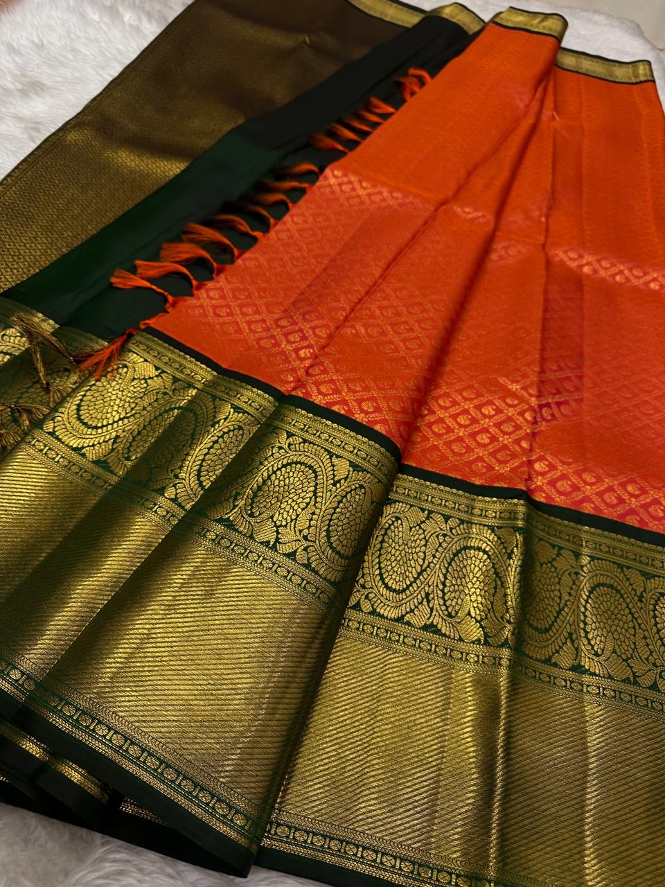 Ember Orange Kanchipuram silk with fine gold Zari Kattam geometry.