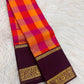 Vivid orange and Rani pink checks of a Paalum Pazhamum Kanchipuram saree.