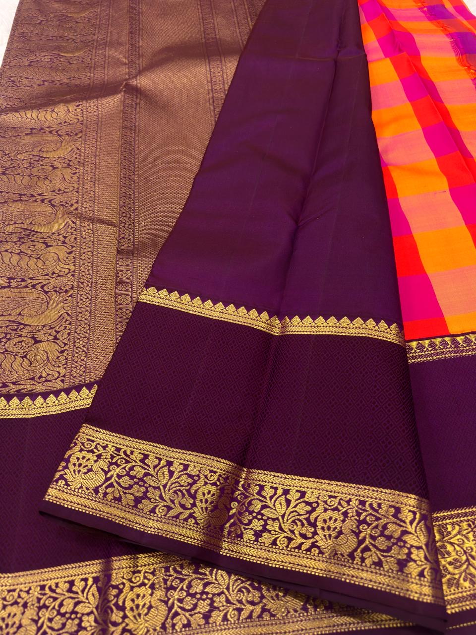 Orange and Rani pink Pure Silk Kanchipuram saree with an aubergine border.