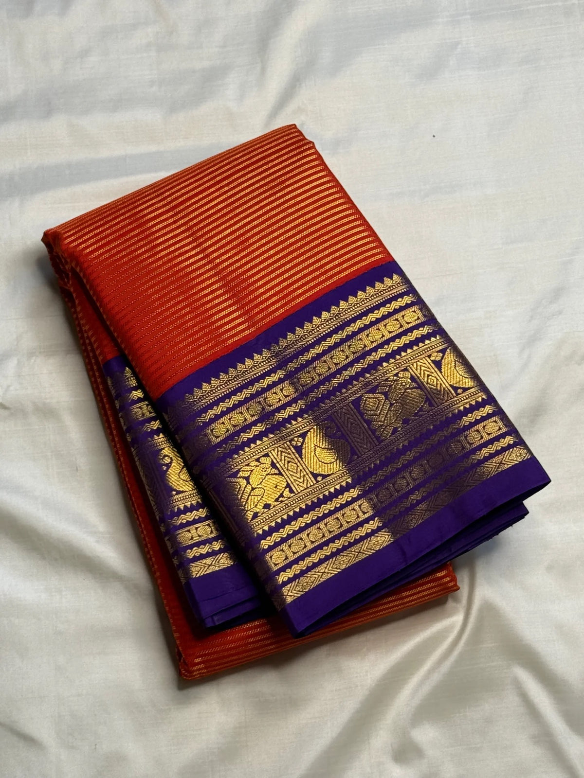 Handwoven Korvai saree with Royal Purple contrast border and antique-gold paisley motifs.