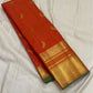 vermillion orange kanchipuram silk saree body with gold paisley buttas