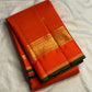 Fine gold hairline Kattam across vivid Orange silk.