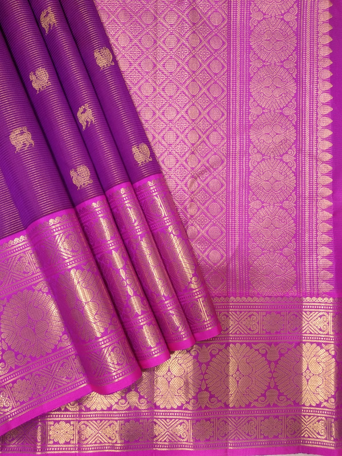 Folded orchid pink Vairaoosi Kanchipuram silk with fine zari lines and richly detailed petal pink lotus border