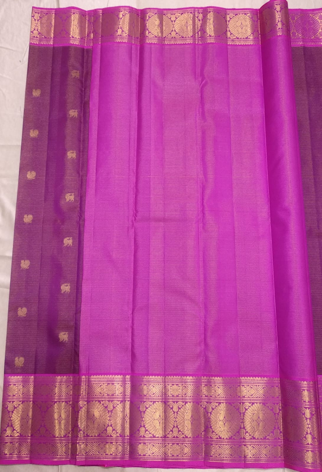 Full laid-out orchid pink saree with fine parallel silk lines and a contrasting petal pink floral zari pallu