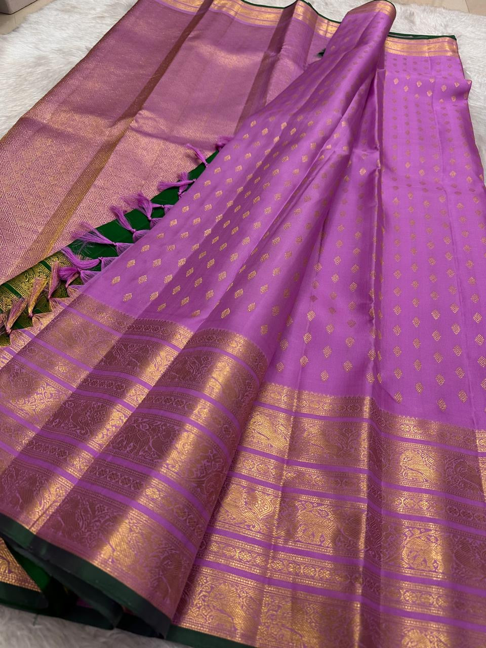 Gold zari border and petite buttas on an orchid-lilac handwoven pure silk Kanchipuram saree