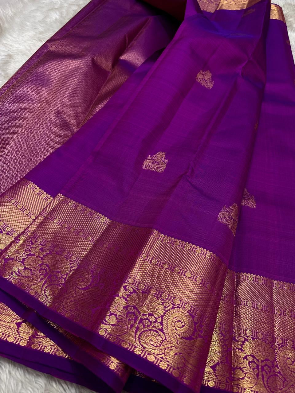 Orchid purple Kanjivaram saree with elegant zari buttas and korvai border