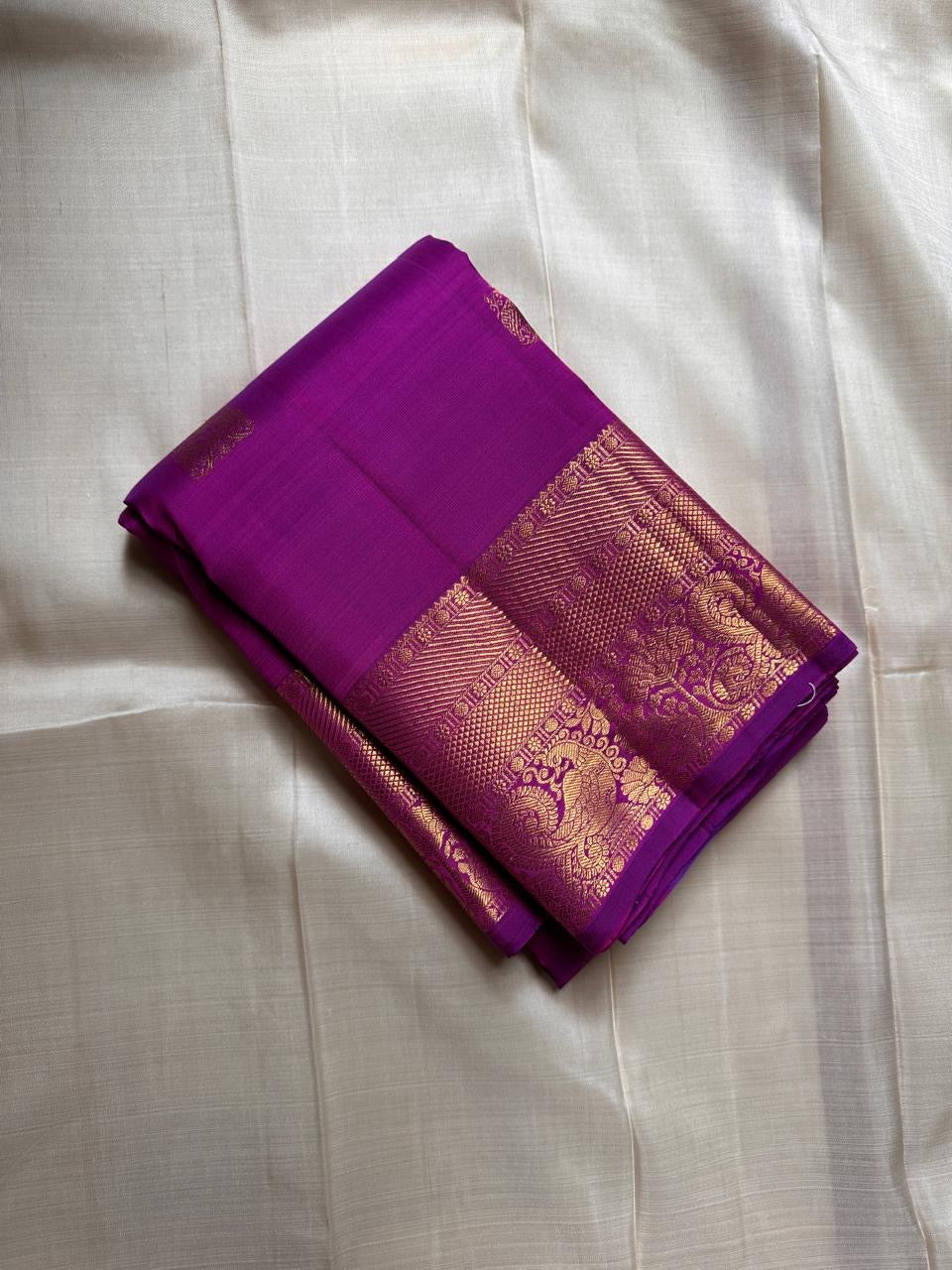 Close view of the orchid purple Kanchipuram saree showing the gold zari border and pallu