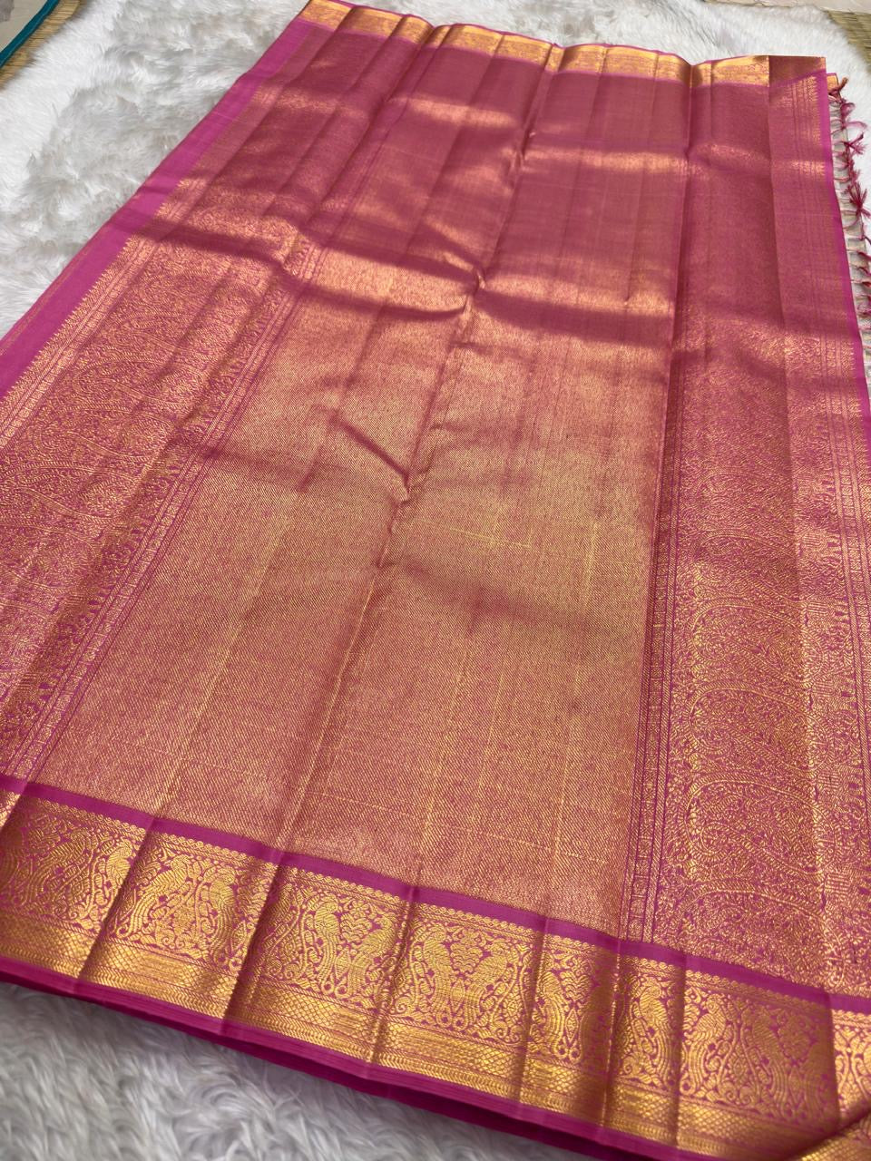 Soft Lotus Pink Kanchi Pattu silk with gold-zari ornament.