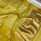 Close view of Turmeric Gold Chanderi saree showing petite gold buttas, fine checks and large floral foliage border motif