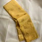Close folded view showing alternating gold zari buttas across the Butter Yellow silk body