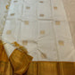 Close view of handwoven Mayil zari buttas on Warm Ivory silk