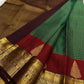 Paaku Brown border with classic-gold zari ornamental bands on the Maragatham Green Kanchipuram.