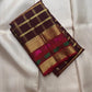 Dark aubergine-maroon Kanchipuram body with fine restrained classic gold zari Kattam checked framework.