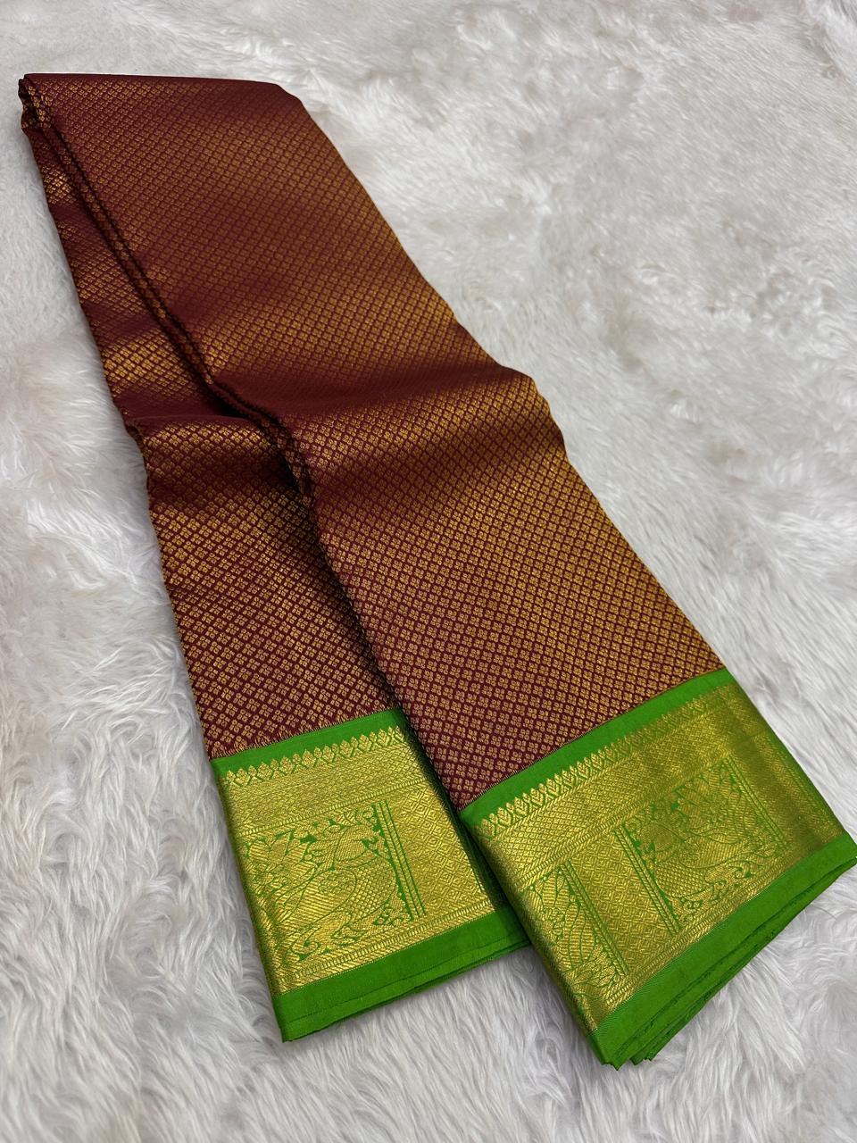 Close-up of regularly spaced gold Zari Kattam lattice on reddish areca-brown silk