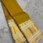 Rich Paal Vellai Kanchipuram mundhanai with dense classic-gold zari and long ornamental vertical registers.