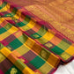 Multicolour silk body showing Kili Pachai, Mambazham and pomegranate-toned checks with spaced gold zari motifs.