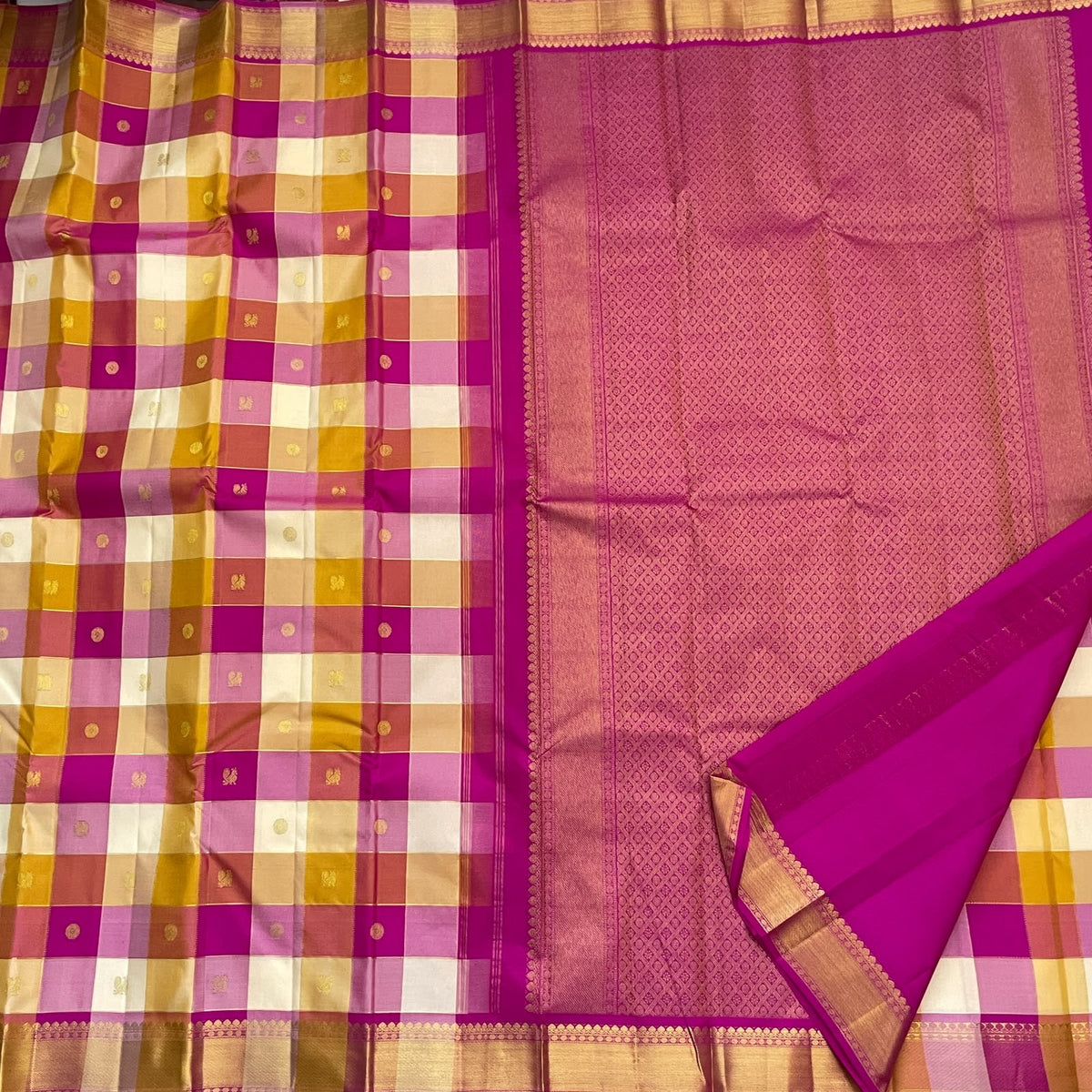 Close view of multicolour Paalum Pazhamum checks with individually woven antique-gold zari motifs.