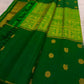 Rich antique-gold pallu with geometric zari field and elephant motifs on Pachai Green Kanchipuram silk.