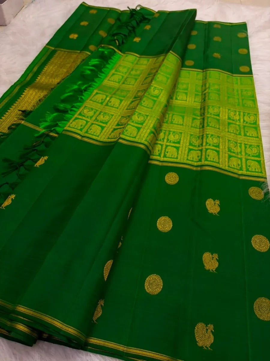 Rich antique-gold pallu with geometric zari field and elephant motifs on Pachai Green Kanchipuram silk.