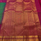 Close view of warm-gold ornamental zari registers on saturated Rani Pink Kanchipuram border.