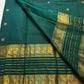 Close view of luminous gold zari buttas across Deep Pachai Green pure mulberry silk.