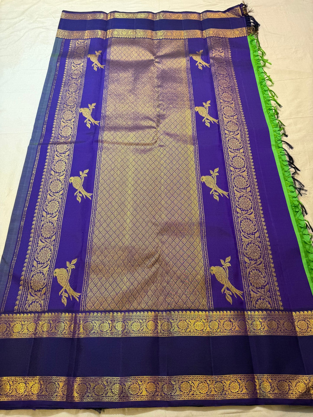Close view of gold zari buttas on Pachai Green Kanchipuram silk
