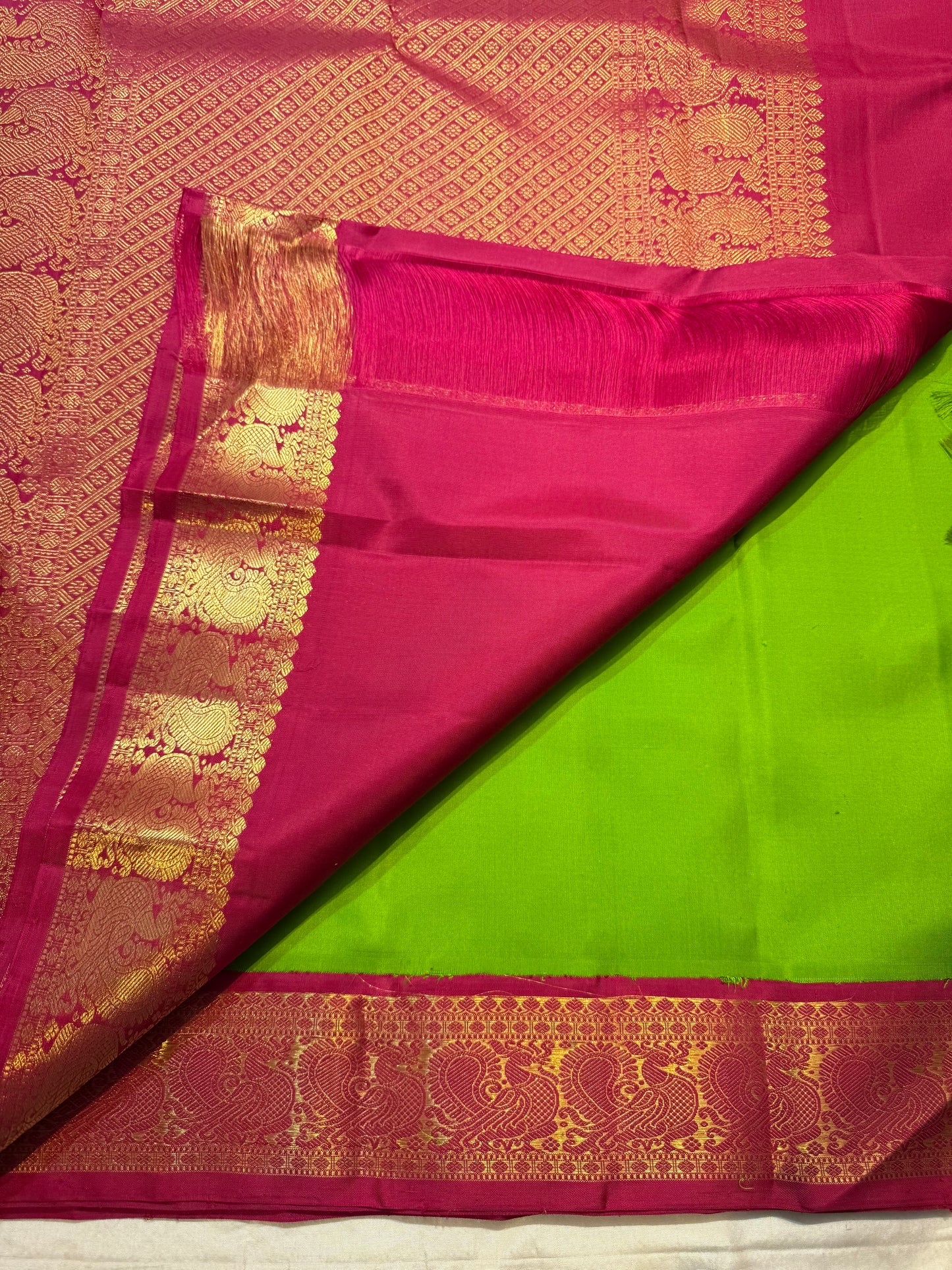 Pachai Green Kanchipuram saree with small Deep Magenta antique gold zari border
