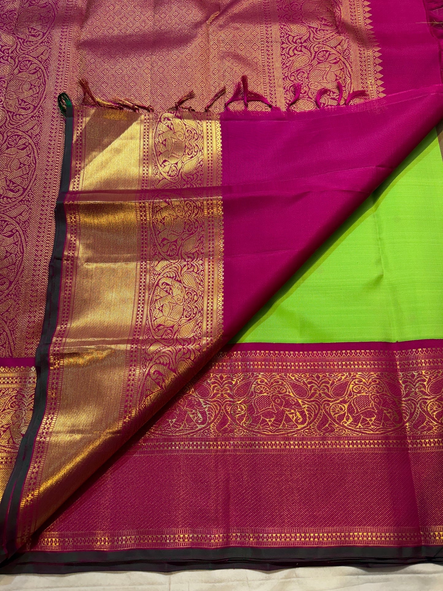 Pachai Green pure silk Kanjivaram Korvai saree with silk-thread buttas and Rani Pink antique-gold Yaanai border.