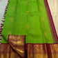 Bright green handwoven Kanchipuram Korvai saree with tiny pink and green silk-thread buttas.