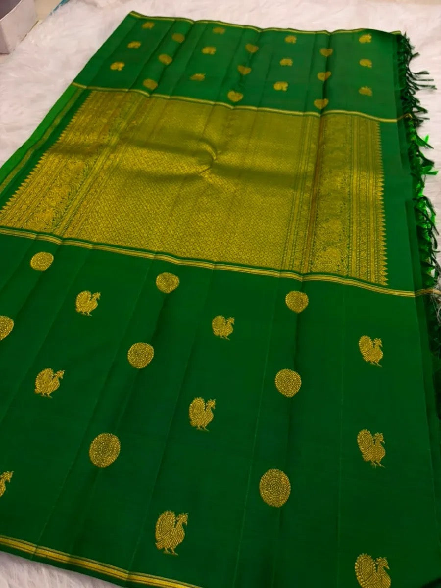 Pachai Green Kanchipuram saree body with alternating antique-gold ornamental and bird zari buttas.