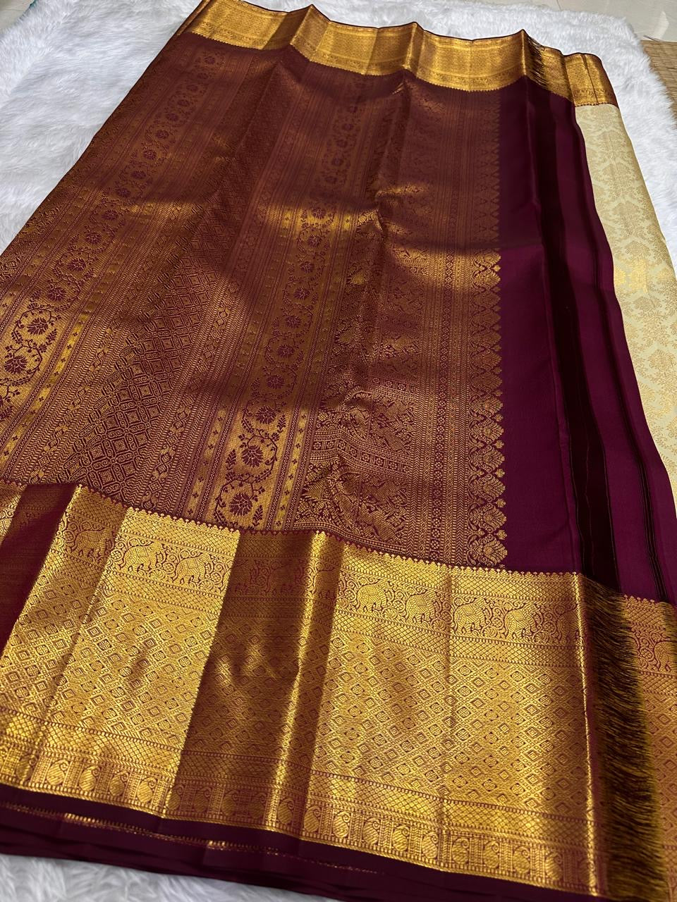 Close detail of Kumkumam Red Kanchipuram border with Pakshi-inspired gold zari and geometric framing.
