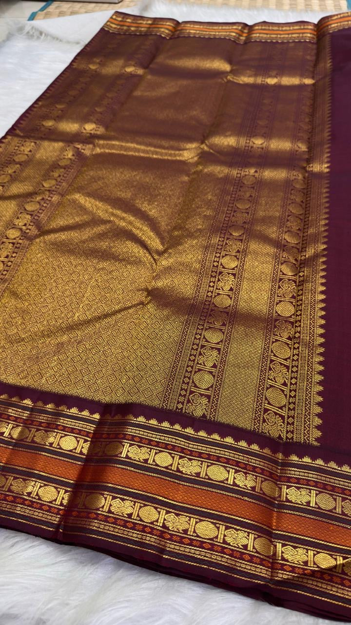 Open Pale Blush Pink Korvai silk showing alternating gold zari buttas and richly woven Aubergine border.